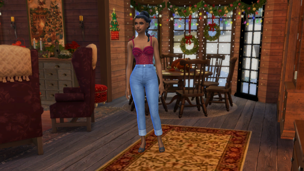 Un sim avec un jean taille haute bleu et un body corset rouge, les cheveux tressés. Ce sim se tient dans une pièce décorée pour Noël.