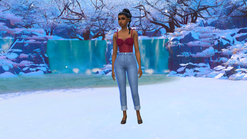 Un Sim en jeans taille haute bleus et un body corset rouge avec les cheveux tressés. Ce Sim se tient dans une zone enneigée du Mont Komorebi dans Les Sims 4 en tant qu'arrière-plan de CAS.