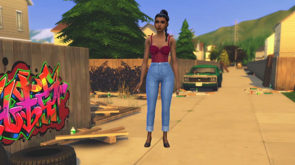 Un sim en jean taille haute bleu et un body corset rouge avec les cheveux tressés. Ce sim se tient sur une rue sale dans Les Sims 4.