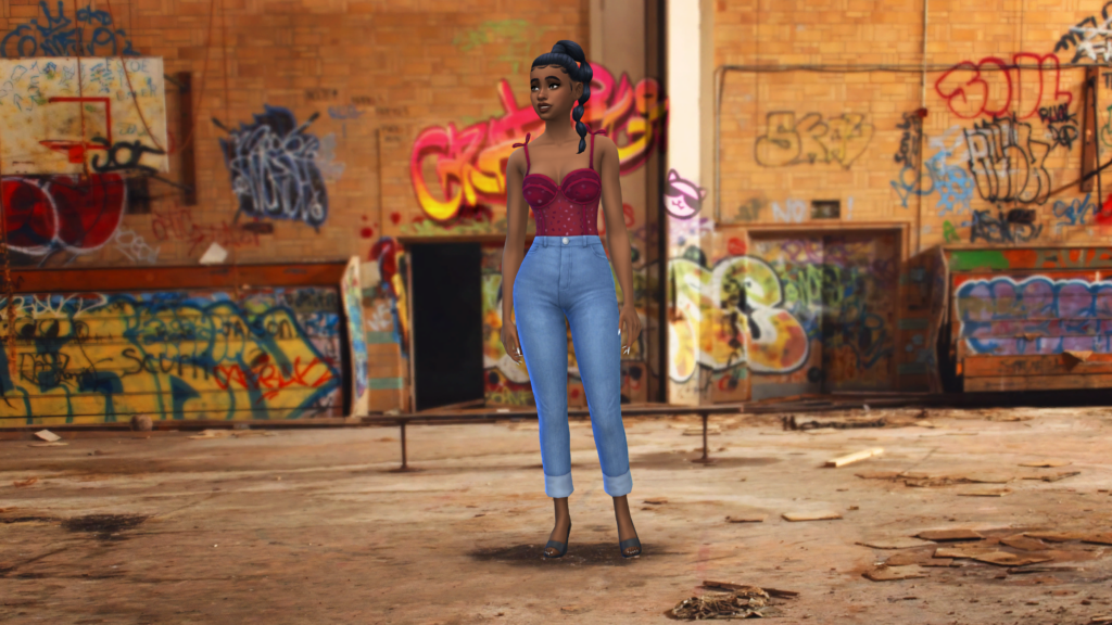 Un sim en jean taille haute bleu et un body corset rouge avec les cheveux tressés. Ce sim se tient dans une ruelle remplie de graffiti et de déchets.