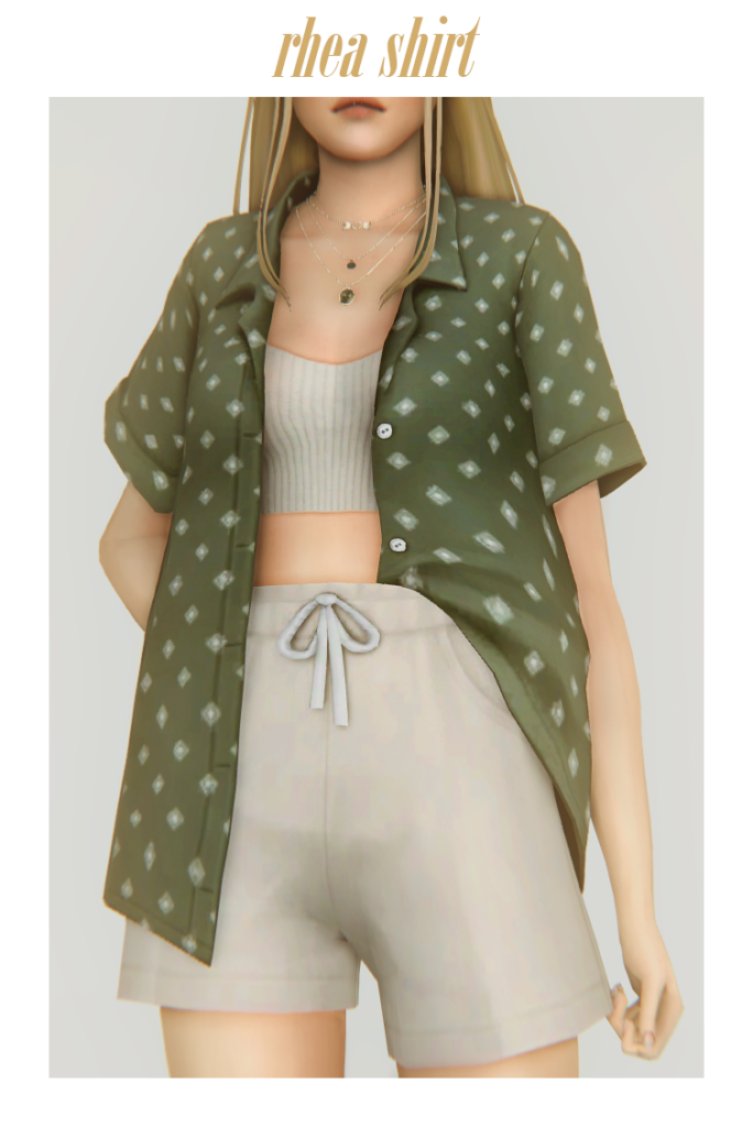 Un Sim portant un haut brassière avec des côtes sous une chemise verte boutonnée ouverte avec un col et un joli motif, la chemise est rentrée d'un côté