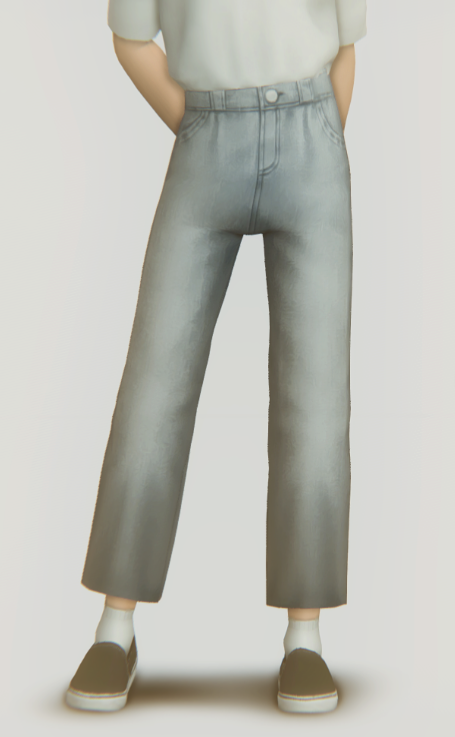 Un sim portant un t-shirt blanc et un pantalon large gris qui est coupé, ils portent des vans et une paire de chaussettes blanches.