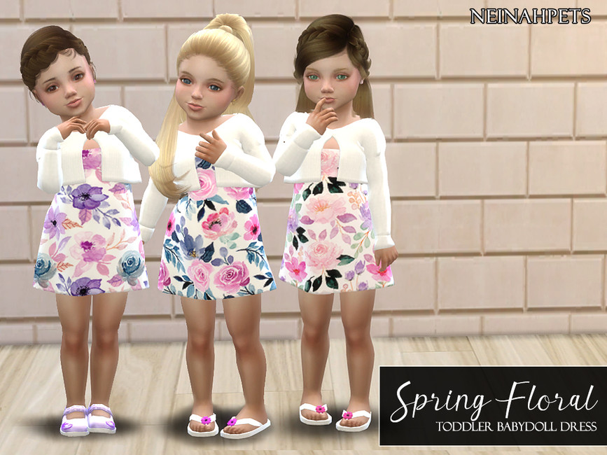 Trois tout-petits différents portant une robe fleurie de printemps avec un petit pull blanc.