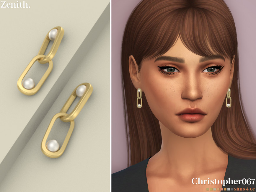 Un sim avec des cheveux bruns, des yeux verts et des taches de rousseur. Ils portent des boucles d'oreilles en or avec deux maillons de chaîne avec des perles à l'intérieur.